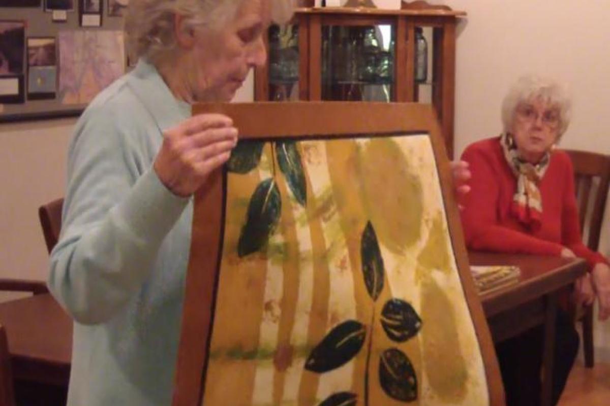 Historian Ellen Kennedy demonstrating rug making